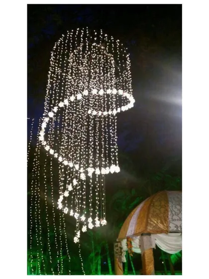 Lighting is crucial for setting the mood. This spiral chandelier made of fairy lights is a stunning centerpiece we created for an evening event, adding a touch of magic and wonder to the decor.