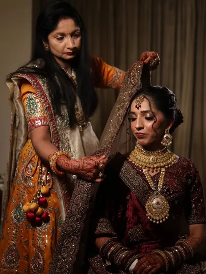 A precious moment of setting the dupatta on my bride. Ensuring every detail of the hair and headpiece is perfect is a key part of my process for creating a complete bridal look.
