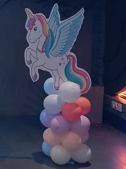 A winged unicorn cutout on a pastel balloon pillar, one of the many details from the party.