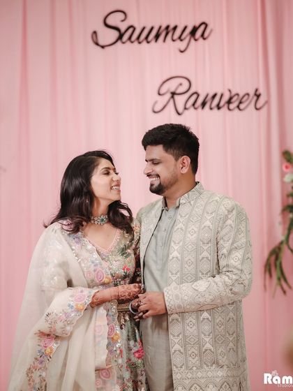 A lovely candid moment from an engagement party. The couple's names in the background add a personalized touch to this photo of them sharing a happy, private conversation.