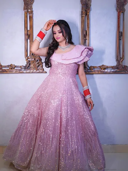 A full-length portrait showcasing the complete pink glitter gown.