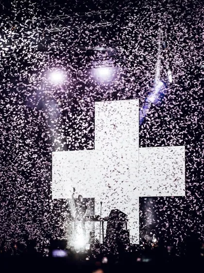 A celebratory shot of Martin Garrix against his iconic cross logo, showered in confetti after being crowned the world's number one DJ.