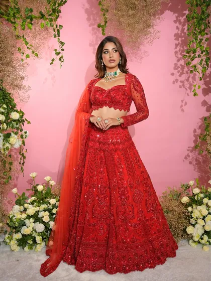 A full-length view of the sister of the groom's glamorous red outfit, paired with our signature makeup that ensures she stands out.