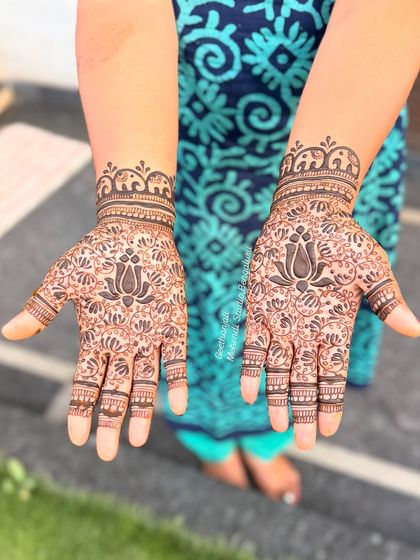 A clear shot of the dense, lotus-filled palm design for Divya.