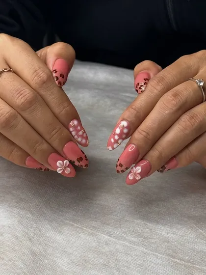 A closer look at the pastel floral nail art, showing the precision and steady hand required to create such detailed and charming designs.