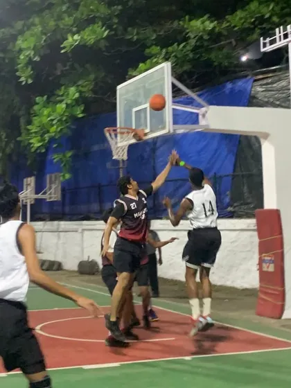 Dominating the court one basket at a time. An aggressive move to the hoop results in a tough, contested layup.