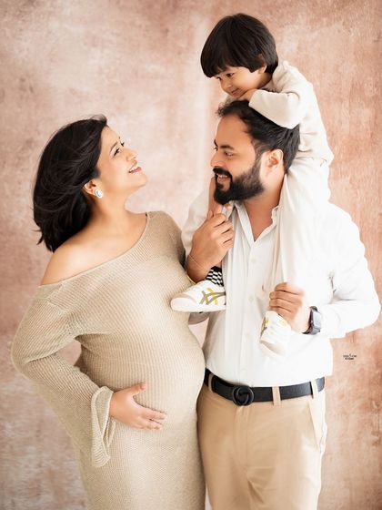 A fun and playful family shot. The little one on his dad's shoulders is just adorable.