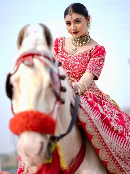 For a grand entrance, your hairstyle needs to be as stunning as your outfit. Here, I created a look with a secure updo and elegant details that stayed perfect, even for a dramatic outdoor photoshoot. This showcases my work on a modern lehenga look.