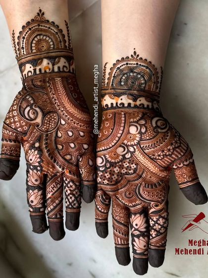 A detailed design featuring tiny elephants on the wrist cuff and a central paisley motif, with full coverage on the fingers.