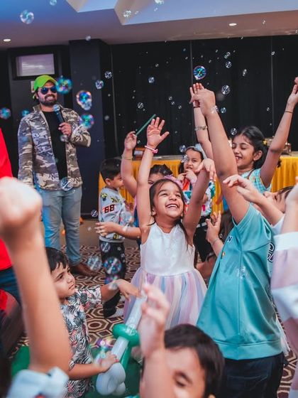 A bubble show entertainer gets the kids excited and reaching for the sky as he fills the room with bubbles. It's pure, simple joy.