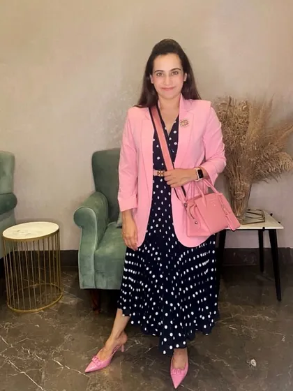 Here is an example of a complete look where color plays a leading role. I have paired a classic navy polka dot dress with a structured pink blazer and matching accessories to create a polished, confident, and harmonious outfit perfect for a professional setting or a stylish day out.