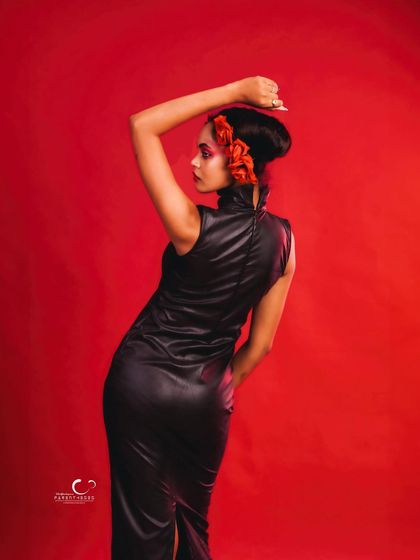 A three-quarter view from the back, showing off the sleek lines of the dress and the creative hairstyle.