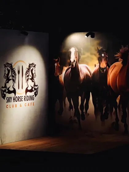 We have designed several Instagram-friendly photo walls around the venue. This spotlit corner with our logo and a dynamic horse mural is a favorite for guests to take pictures at night.