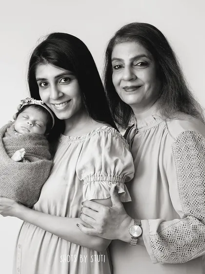 The black and white version of the three-generation portrait, adding a timeless and classic feel.