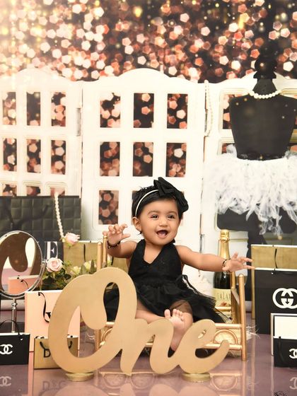 Pure happiness in her own little world of glamour. This shot captures the joy and excitement of a diva-themed first birthday party.