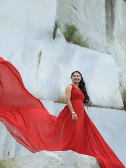 A simple yet powerful portrait focusing on the beauty of a flowing gown against a dramatic, minimalist backdrop. This style of shot emphasizes elegance and grace.