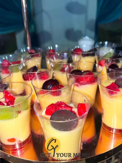 Individual fruit custard cups, a light and refreshing dessert option, beautifully displayed for guests to pick up.