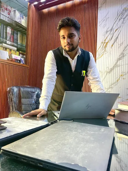 In my office, ready for the day's challenges. Whether it's drafting a legal notice, preparing for a court hearing, or providing a consultation, my focus is always on your legal needs and goals.