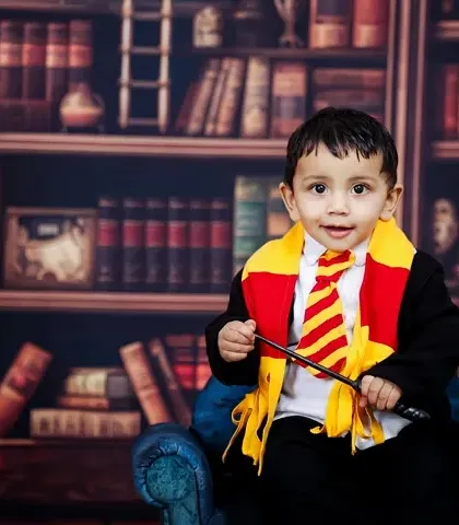 For the little wizards and witches, I bring the magic of Hogwarts to life. This Harry Potter themed shoot is one of my most requested setups, complete with a Gryffindor scarf, a magic wand, and a library backdrop for a truly enchanting portrait.