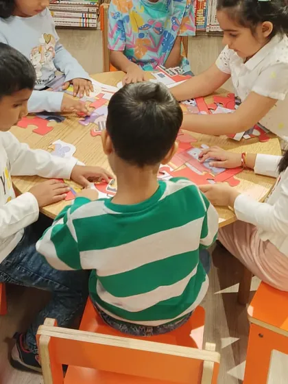 Puzzles are a great way to develop problem-solving skills. Here, a group of children works together to complete a puzzle during one of our activity sessions, learning teamwork along the way.