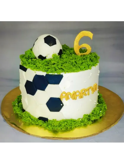 A simple and fun football cake for a 6th birthday. This fresh whipped cream cake has a fondant football and edible grass details.
