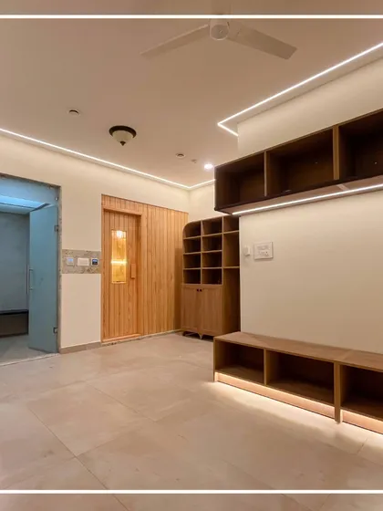 A wider view of the gents' changing room, showing the spacious layout and ample storage solutions. The design prioritizes comfort and practicality for club members.