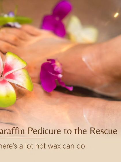 A close-up of feet soaking in a warm paraffin wax bath, infused with floral elements. This treatment provides intense moisture, especially beneficial during dry winter months.