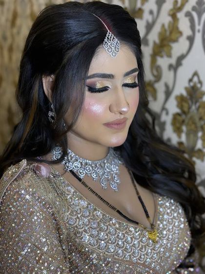 A close-up on the eye makeup for this reception look. The blend of gold and bronze tones creates a warm, glamorous effect that makes her eyes shine.