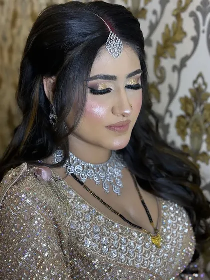 Eyes closed to show the beautiful blend of gold and bronze eyeshadows. This is a versatile glam eye look that suits many different outfits and occasions.