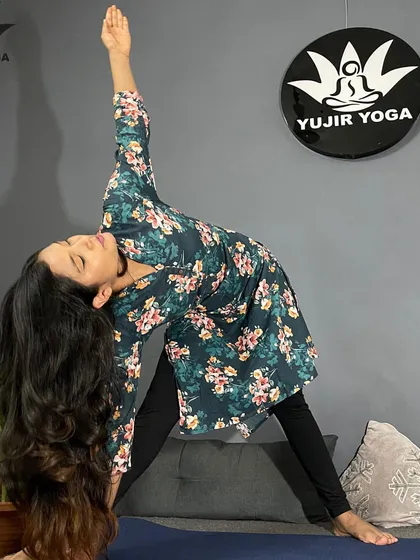Demonstrating Trikonasana, or Triangle Pose. This is a fundamental standing pose that we break down in beginner classes to teach alignment of the hips, spine, and shoulders.