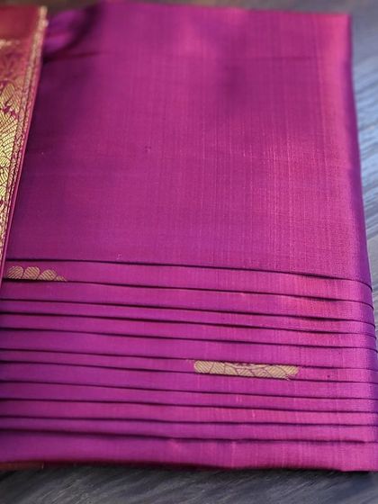 Another view of the neatly folded magenta saree.