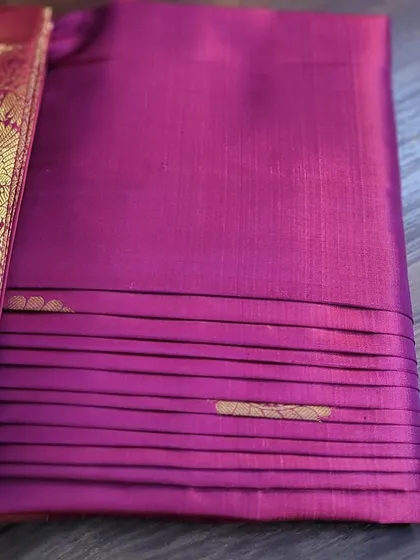 Another view of the neatly folded magenta saree.