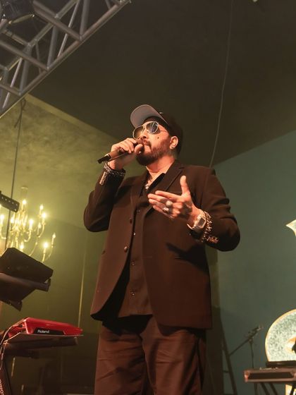 A close-up of Mika Singh performing, showing his stage presence. My productions ensure that even in a club, the artist is the undeniable focal point.