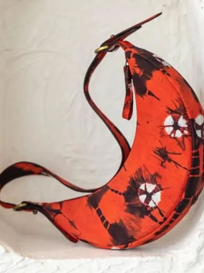 A close-up of the custom Selena Artichoke Red. The intricate tie-dye pattern on the fabric makes each bag a one-of-a-kind statement piece.