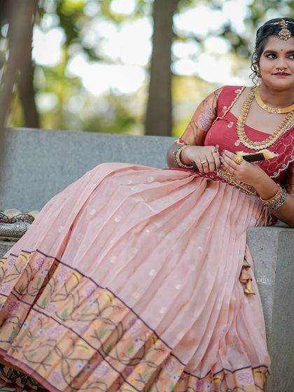 For the Makara Sankranthi festival, I designed this exquisite Zari Kota lehenga for my client. The peach skirt with a traditional border is paired with a red brocade blouse, creating a vision of grace and tradition.