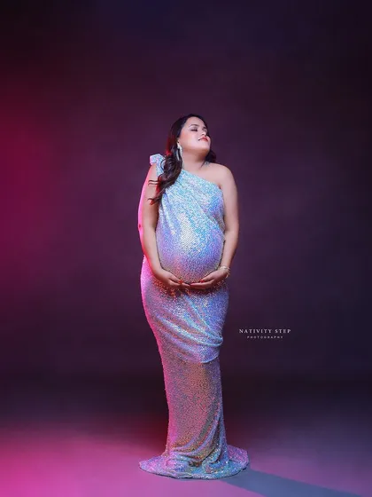 A stunning solo portrait in a shimmering sequined gown. The dramatic pink and purple lighting creates a modern and high-fashion look.