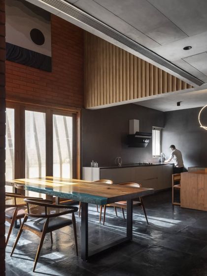 The double-height dining and kitchen area of the Brick House is a testament to our love for local materials and the play of natural light.
