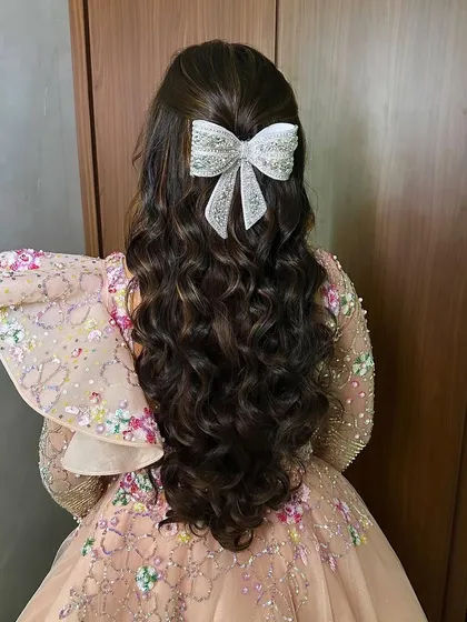 The back view of the princess hairstyle, highlighting the large, sparkling bow.