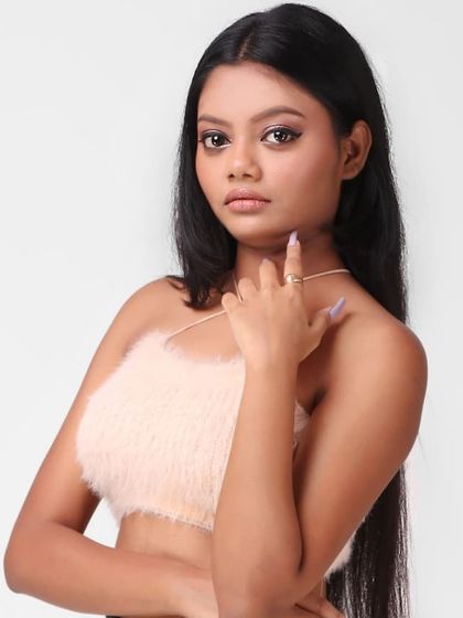 A close-up portrait is key for showing a model's potential for beauty and accessory shoots. This headshot highlights the model's features while wearing a stylish fur crop top.