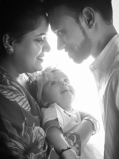 I love using light and shadow to create artistic and emotional portraits. This black and white image captures an intimate, quiet moment between new parents and their baby, focusing on their bond without any distractions.