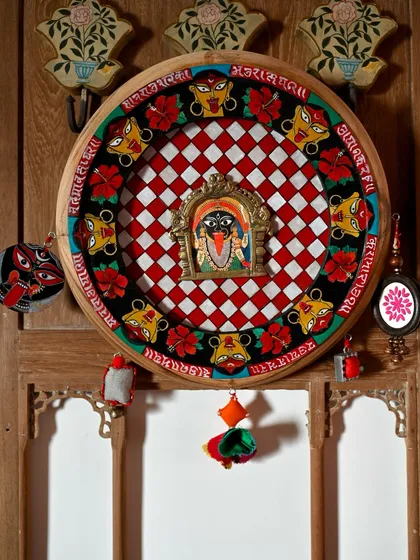 The complete Kaali frame, displayed as a powerful wall art piece. The central Prabhavali is surrounded by hand-painted iconography and embellished with handmade tassels and charms, blending Pattachitra tradition with restorative art.