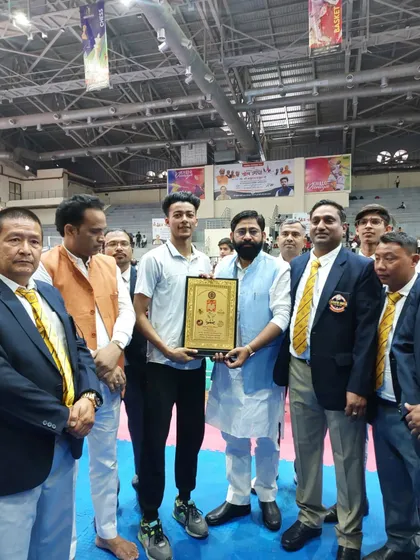 Another photo of Rajat Kashyap being presented with the Award of Honour by officials and dignitaries.