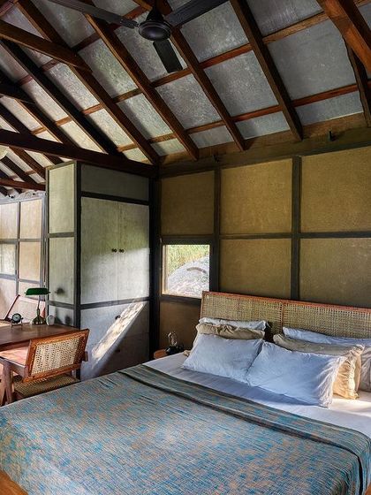 An overall view of the studio cottage interior, showing the open-plan layout that combines sleeping, working, and kitchen areas within a single, cohesive space.