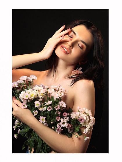 A close-up beauty shot from the floral series, focusing on the model's expression and the delicate flowers.