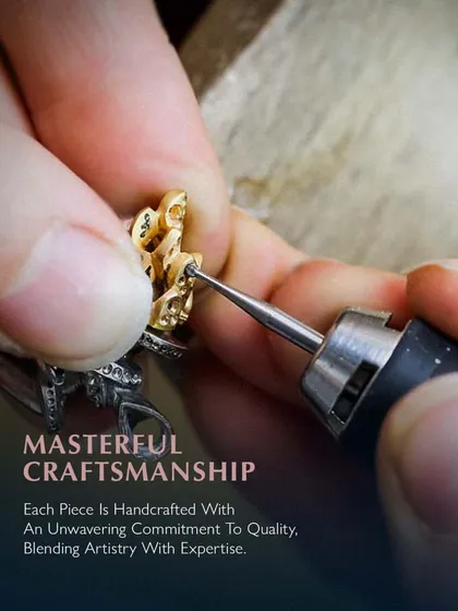 Masterful craftsmanship. Each piece is handcrafted with an unwavering commitment to quality, blending artistry with expertise. Here, an artisan is carefully refining the details of a gold piece.