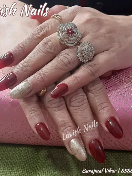 A powerful and elegant combination of deep red and sparkling gold glitter nails, perfect for a bride or festive event.