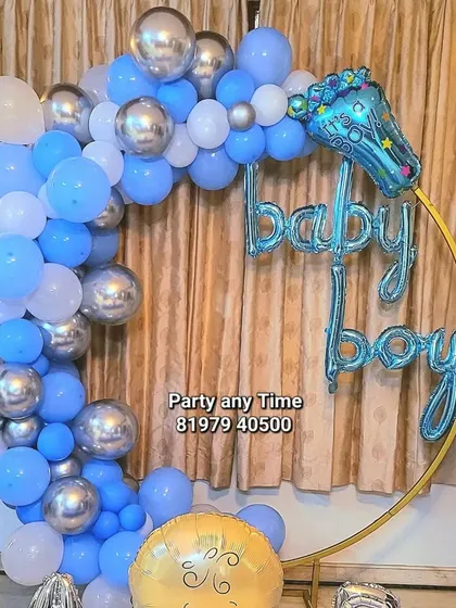 A detailed shot of the blue and silver chrome balloon arch with a 'baby boy' foil balloon.