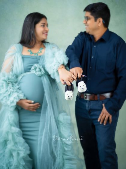 It's all in the details. This sweet shot of the couple holding tiny baby shoes is a perfect way to announce the upcoming arrival.