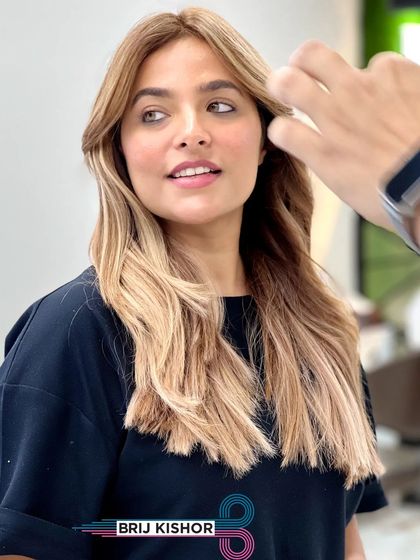 A candid shot of the client enjoying her new creamy peach ash blonde hair.