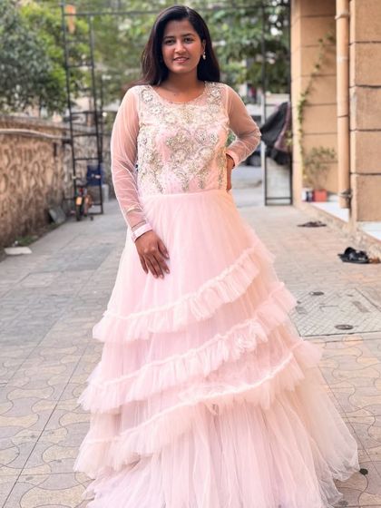 A full-length view of the baby pink ruffled gown. It’s a dreamy outfit that’s perfect for feeling like a princess.